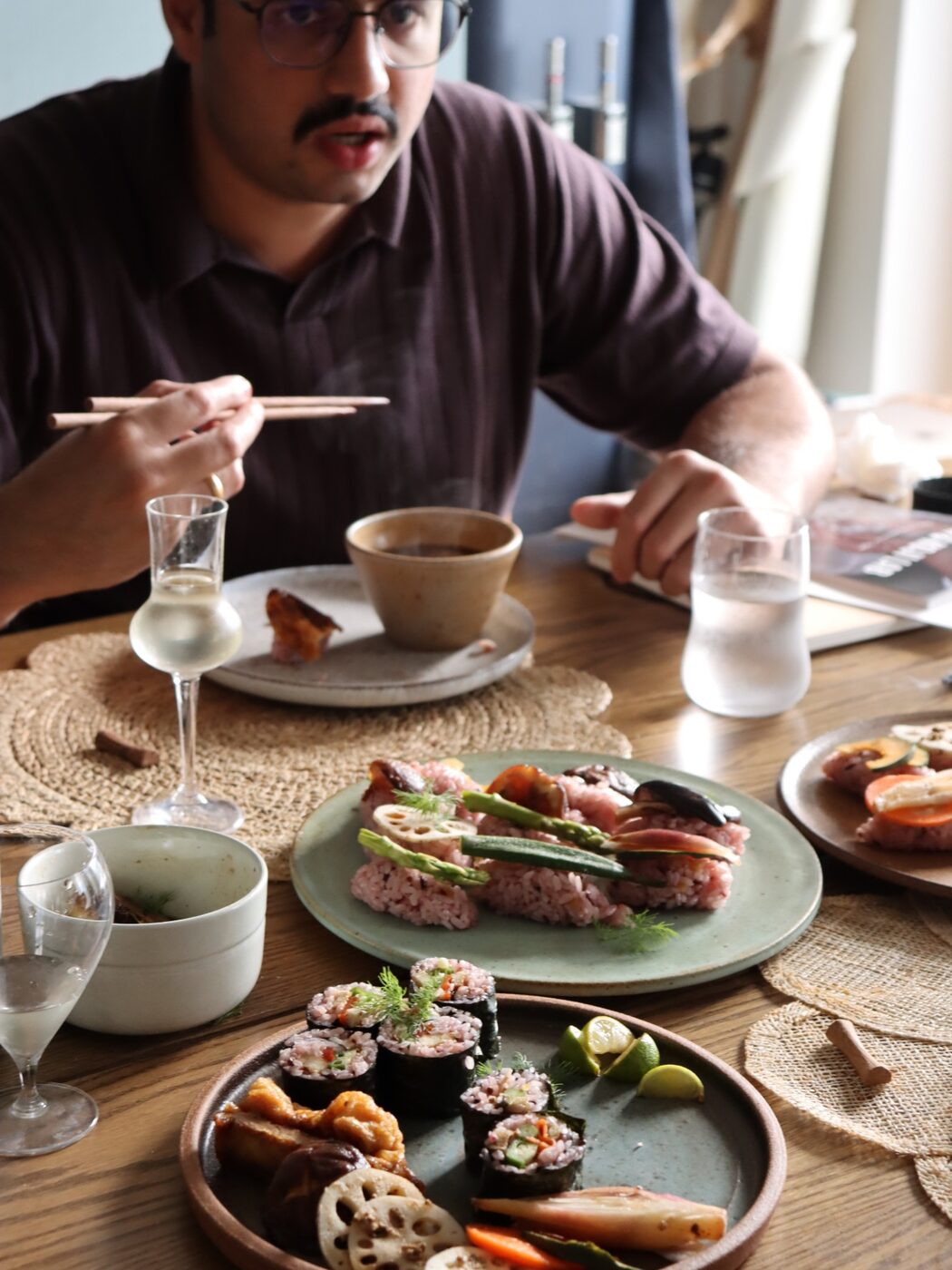 A guest at lunch with vegetable sushi and small dishes made with koji seasonings