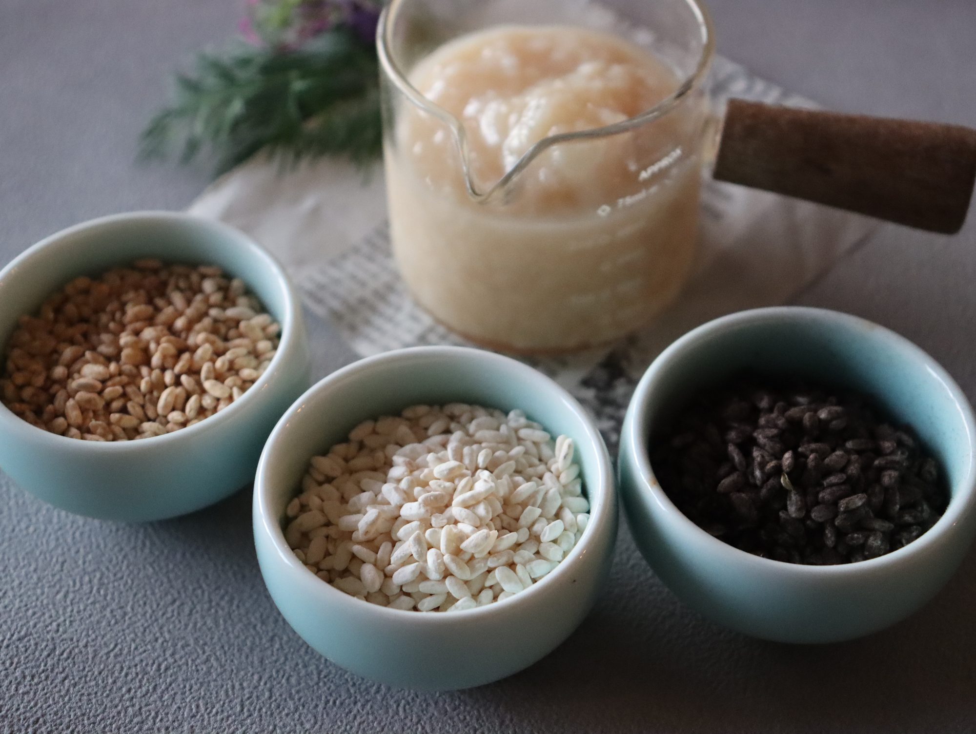 Bowls of rice koji, koji grains and freshly made amazake on a table in a Tokyo kitchen