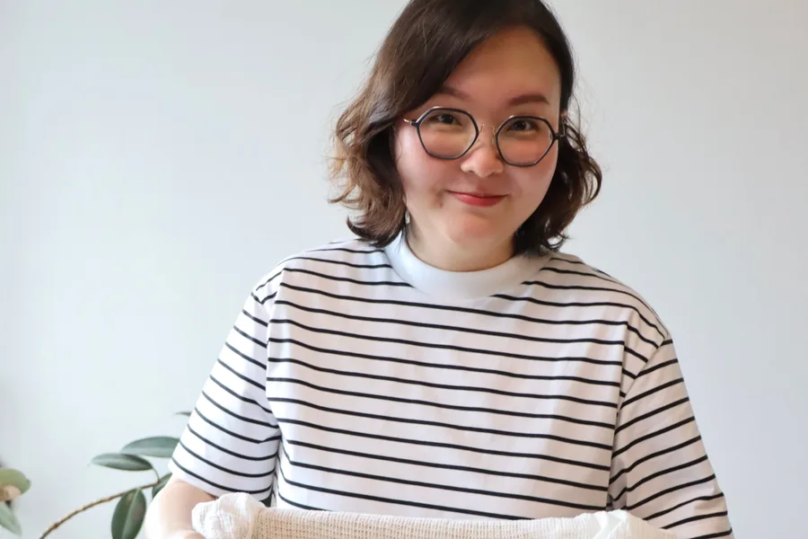 自分で仕込んだ麹の箱を持つ Joy さん